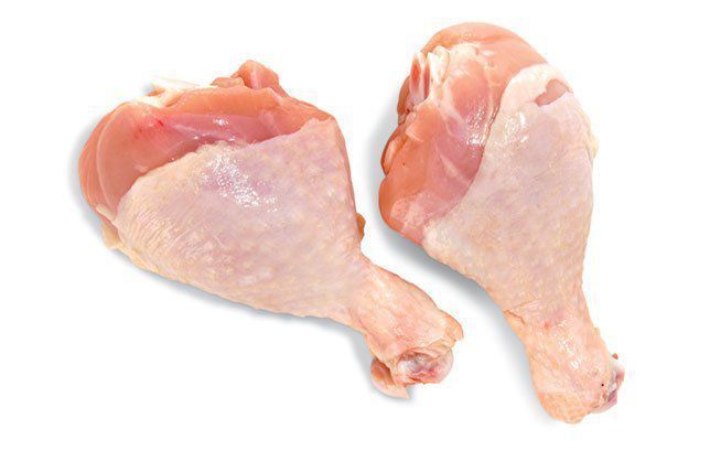 Two raw chicken legs on a white background.