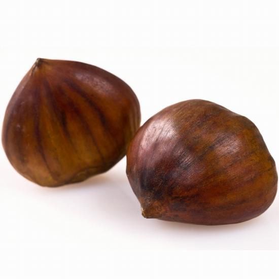 Two chestnuts are sitting on a white surface
