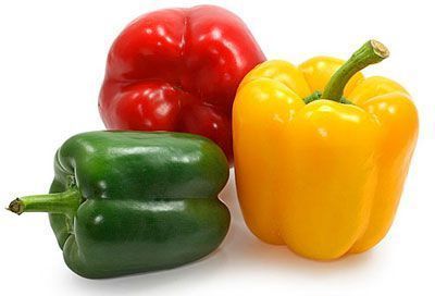 Three different colored peppers are sitting next to each other on a white background.