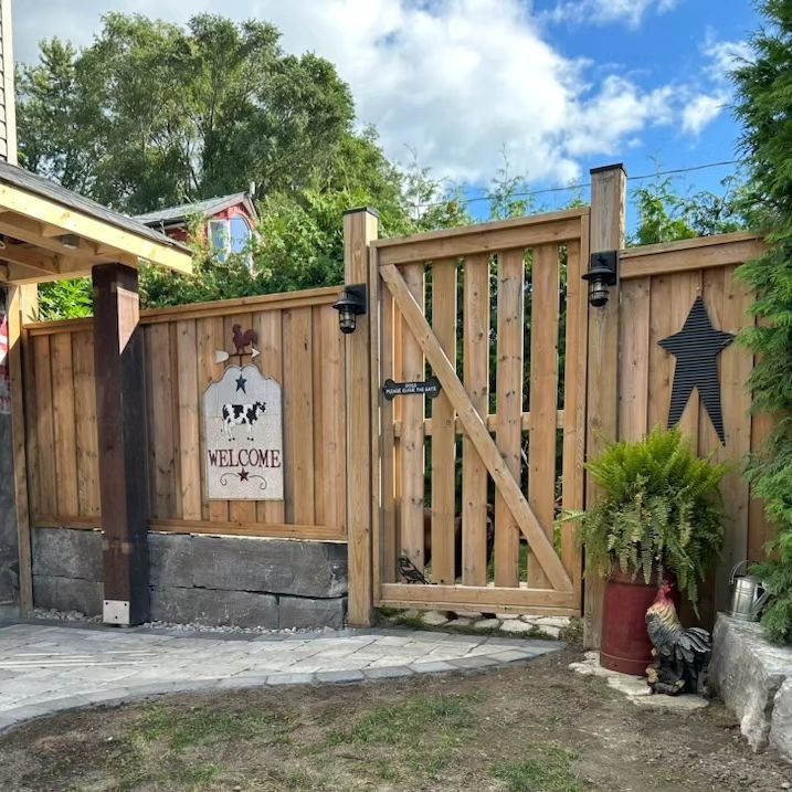 A wooden fence with a sign on it that says welcome