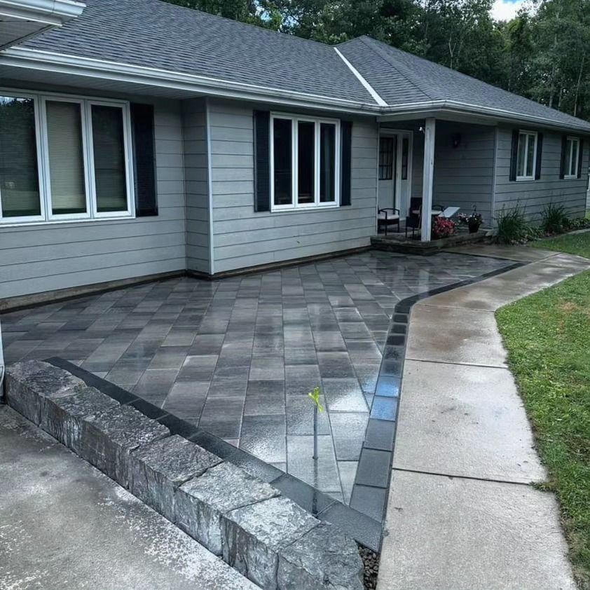 A house with a patio and a sidewalk in front of it