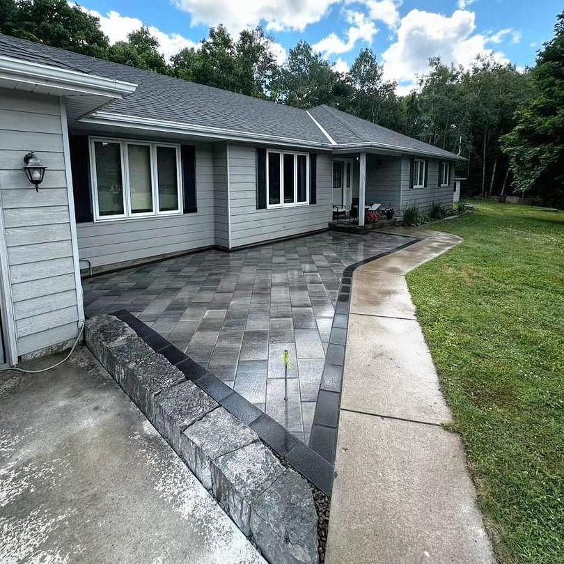 A house with a patio and a sidewalk in front of it