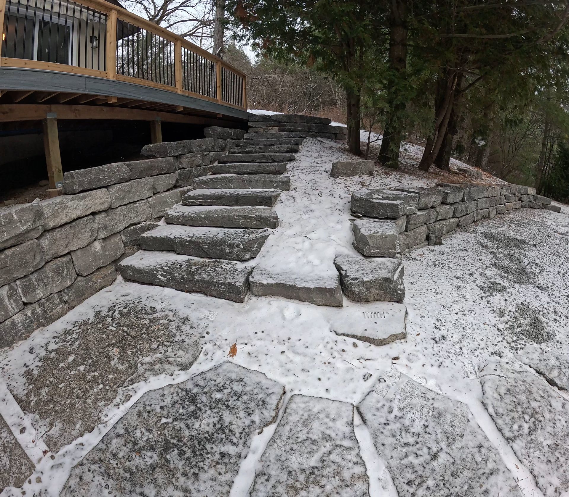 A set of stone stairs leading up to a wooden deck