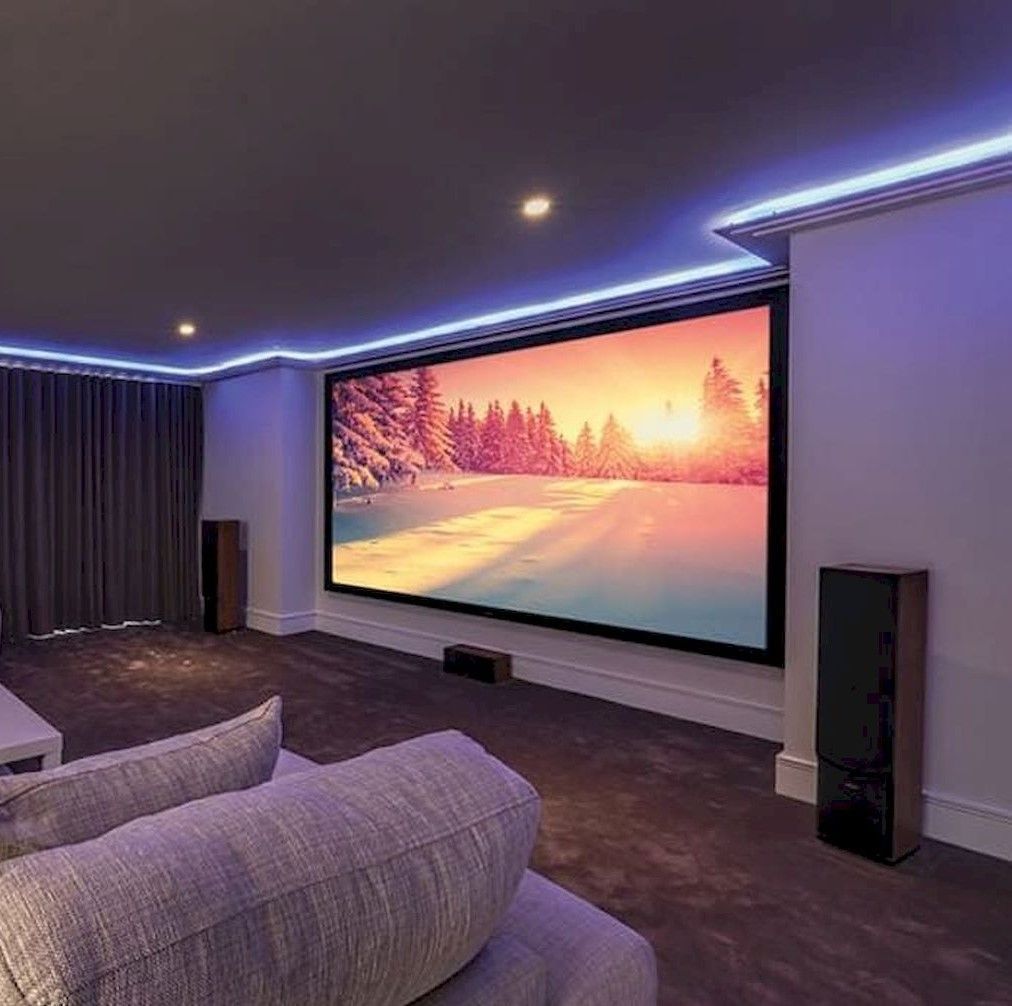 A living room with a large flat screen tv on the wall.