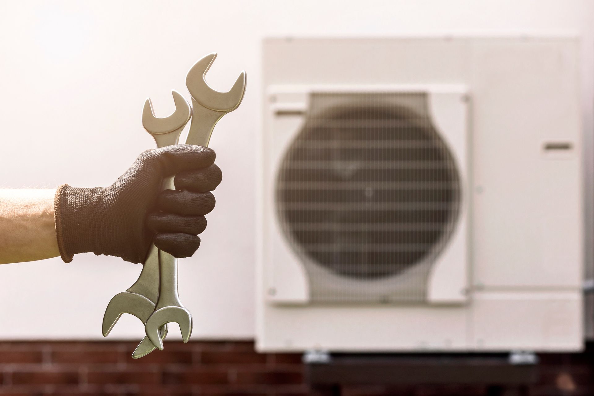 A modern heat pump system installed outdoors with a technician ensuring proper setup.