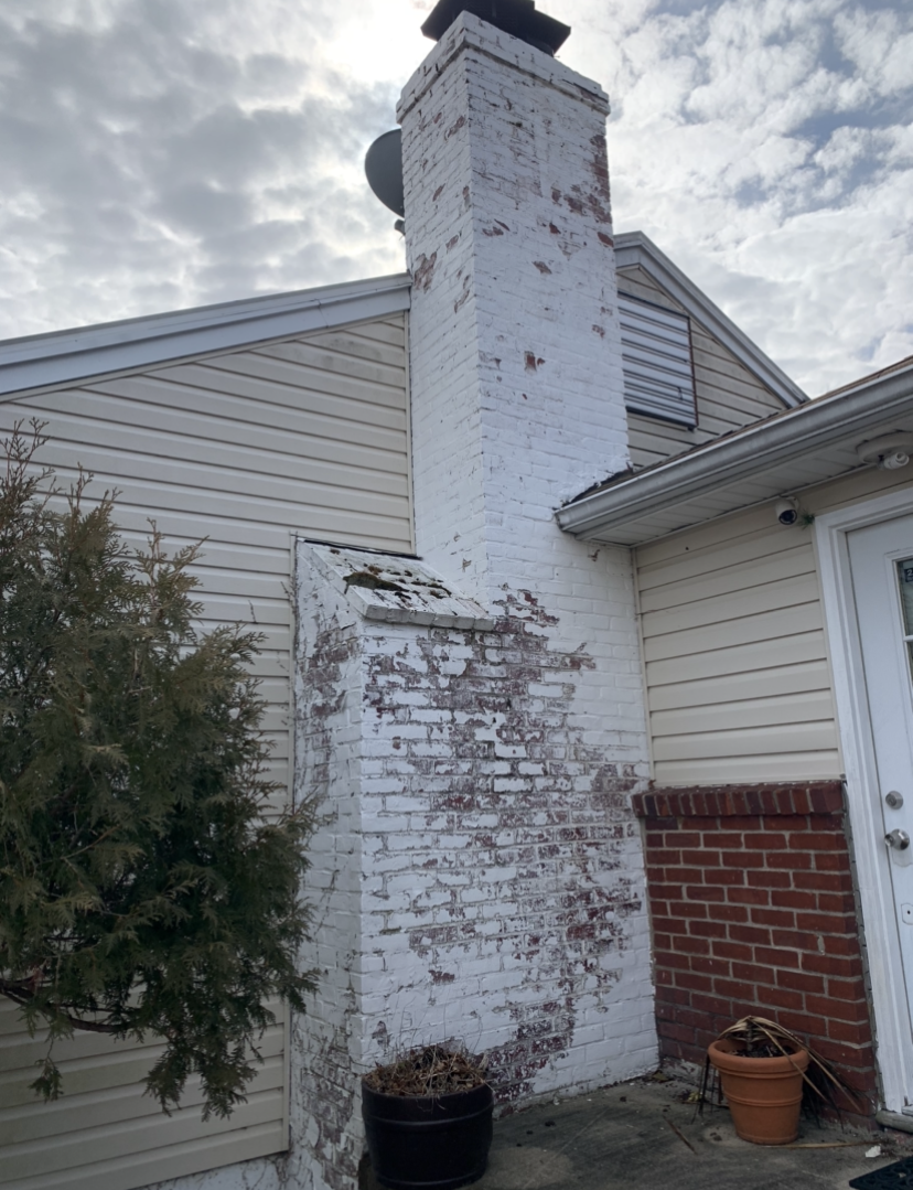 Removing paint from a chimney on a residential home