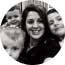 A black and white photo of a woman and two children in a circle.