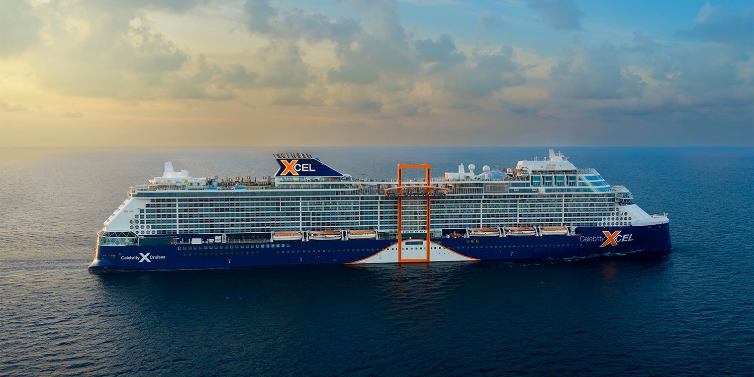 Cruise ship on the ocean, blue and white with orange accents.