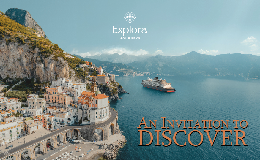 A cruise ship sails near a coastal town on a sunny day. Text: