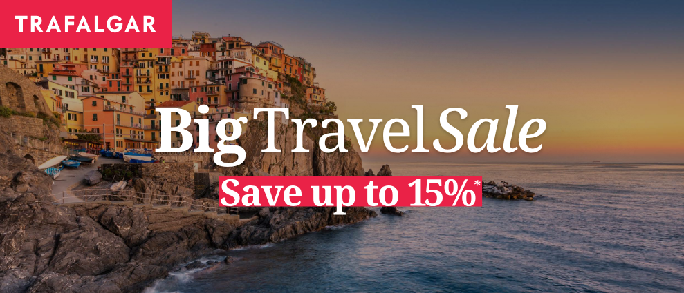 Trafalgar Big Travel Sale with coastal town background, save up to 15%.