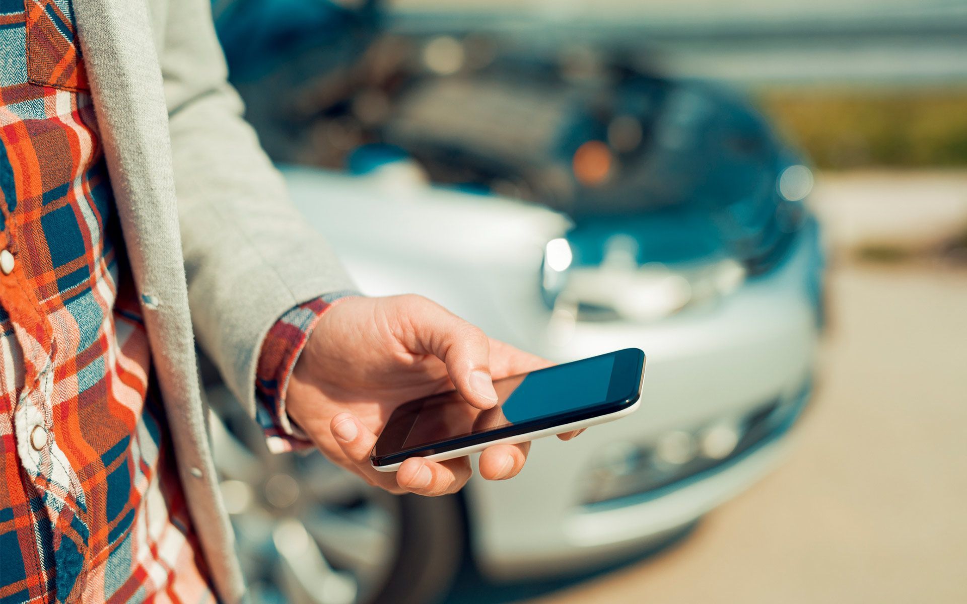 Holding Cellphone — Augusta, GA — Car Plus LLC