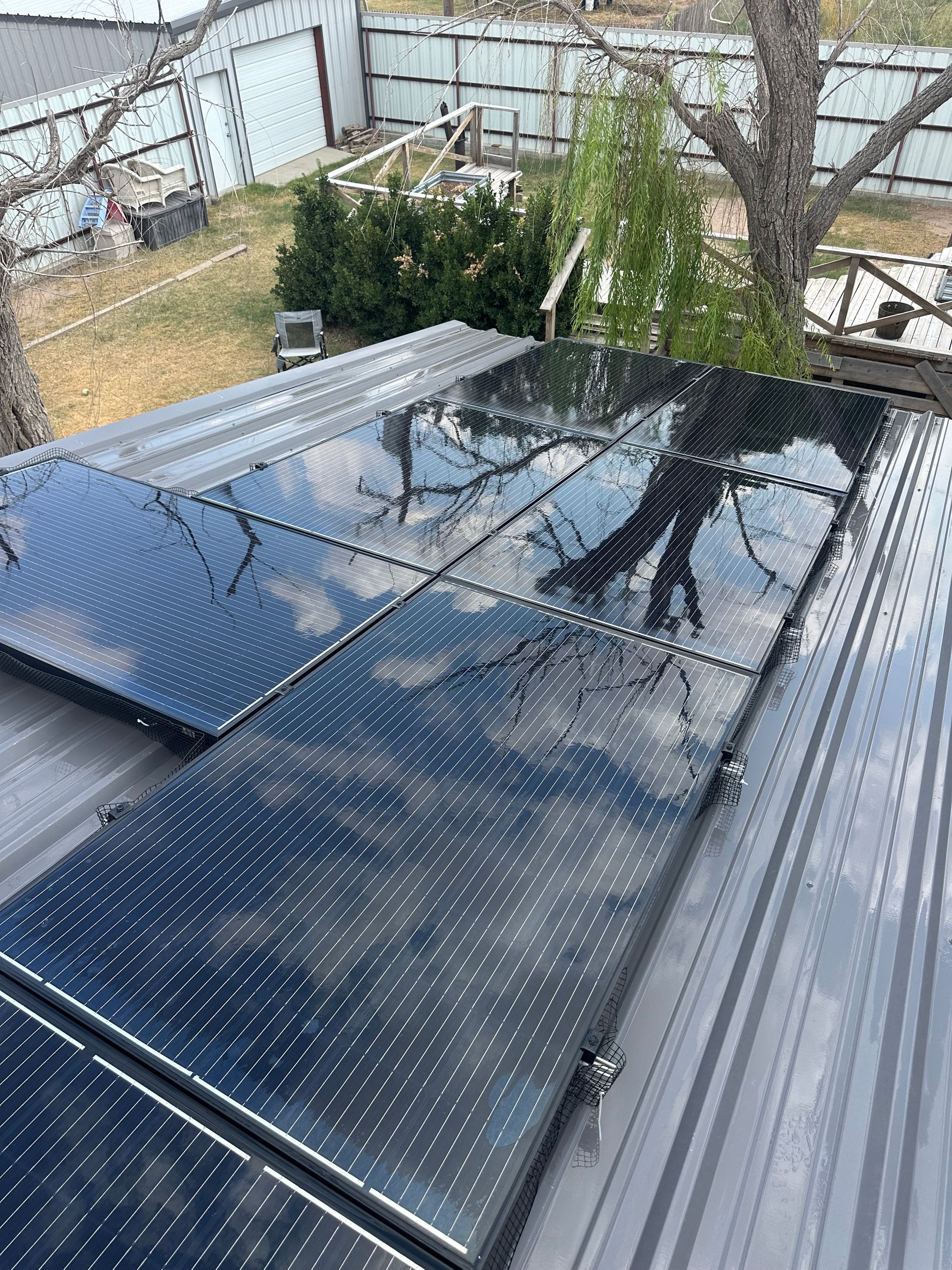 Close-up of ridged metal surface with water droplets, teal and gold hues.