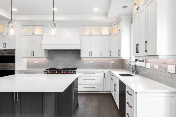 A kitchen with green cabinets and stainless steel appliances.