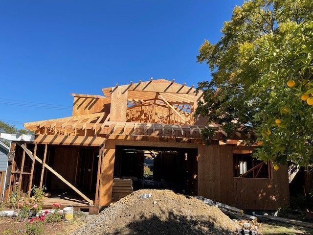 A house is being built with a blue sky in the background.