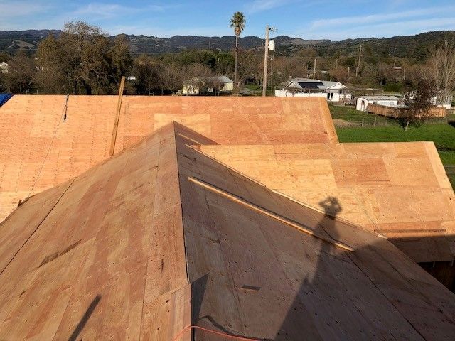 The roof of a house is being built with plywood.