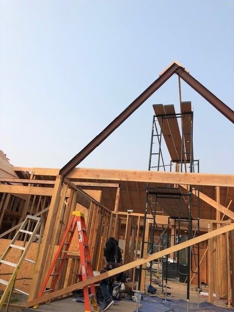 A house is being built with a ladder and scaffolding.