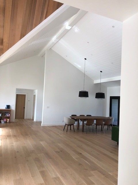 A large room with a table and chairs in it