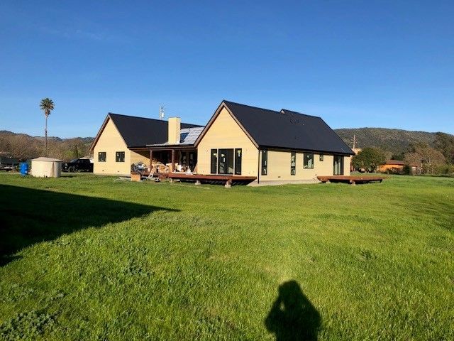 A house with a large lawn in front of it