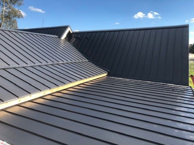 A close up of a roof with a blue sky in the background.