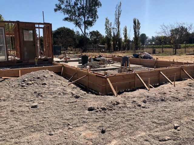 A house is being built in a dirt field