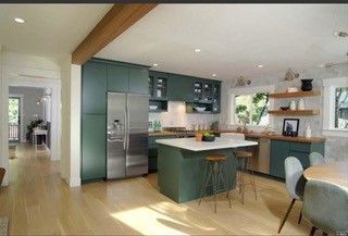 An artist 's impression of a kitchen with green cabinets and a large island.