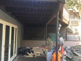 There is a lot of wood on the ground under the deck.