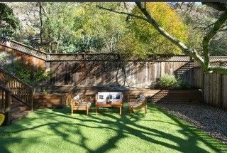 A backyard with a couch , chairs , and a table.