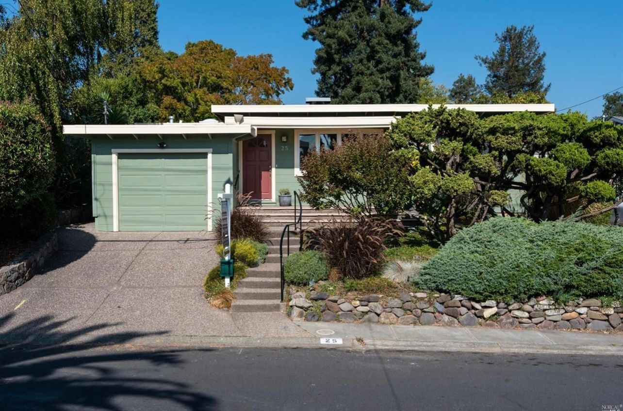 A house with a green garage door and a red door