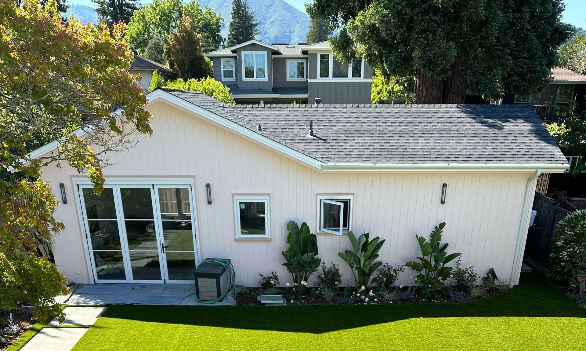 A view of a house from a balcony with a black railing