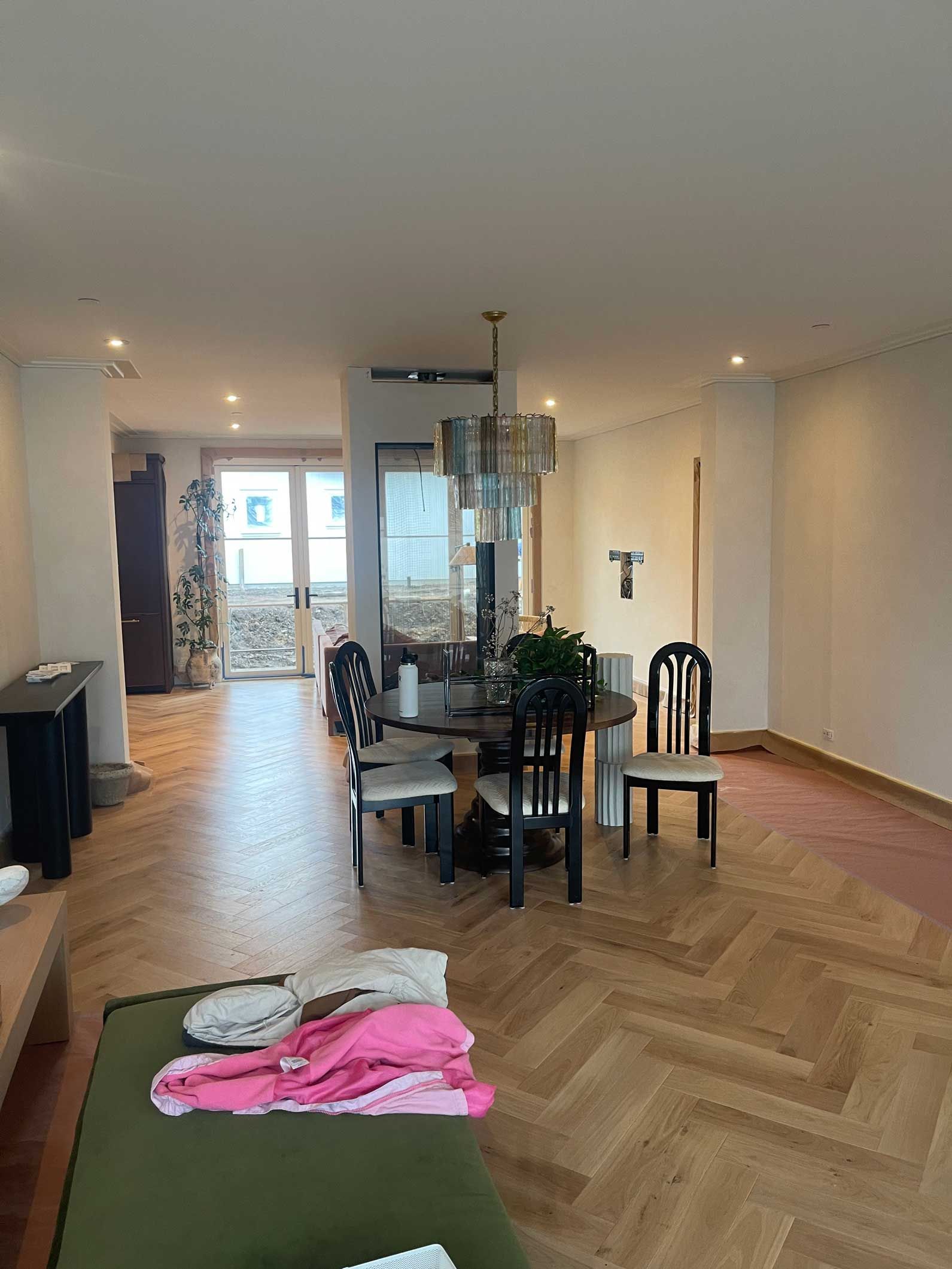 A living room with a table and chairs in it.