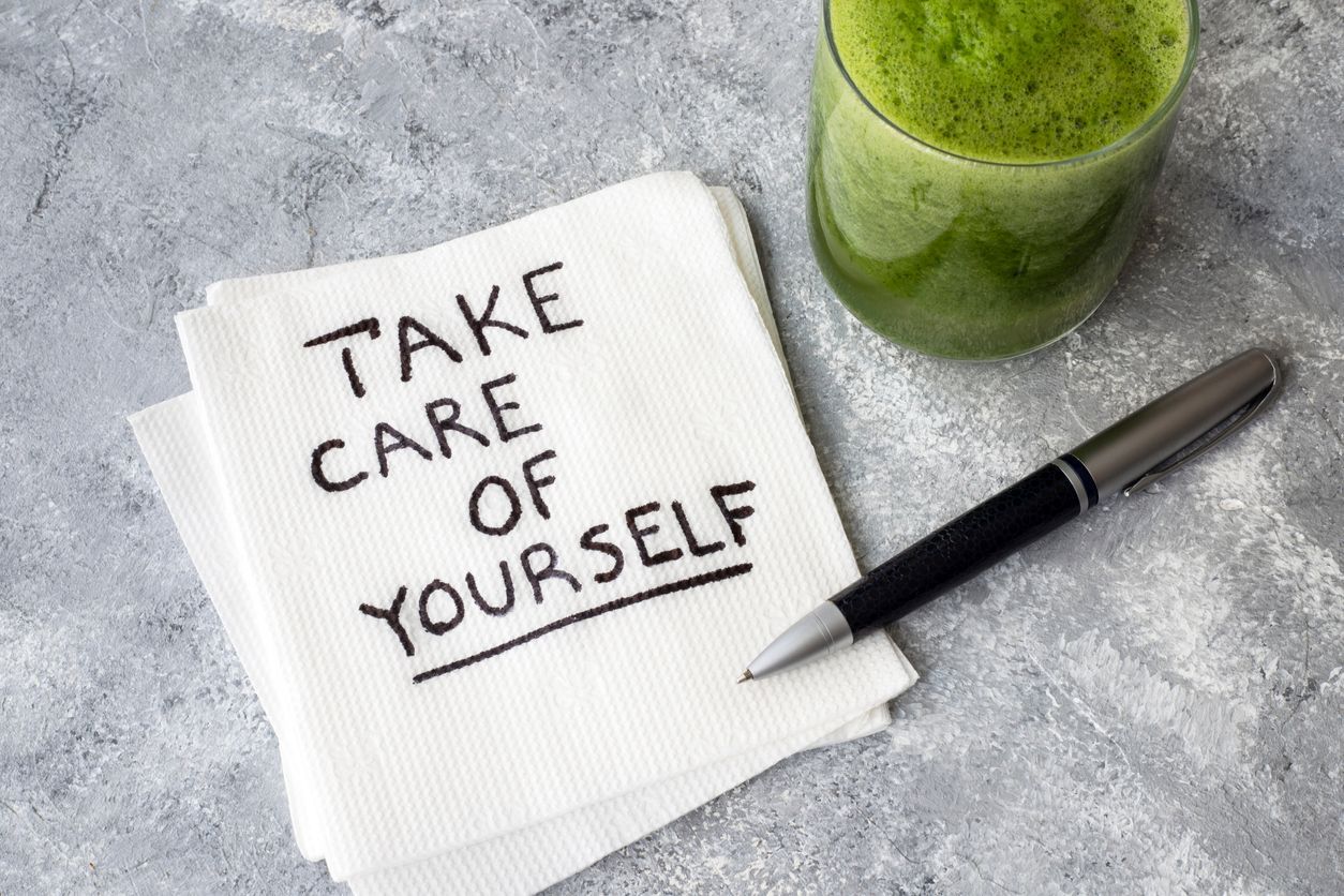 Health Retreat Programs with image of a napkin with the words `` take care of yourself '' written on it next to a pen and a glass of green juice .