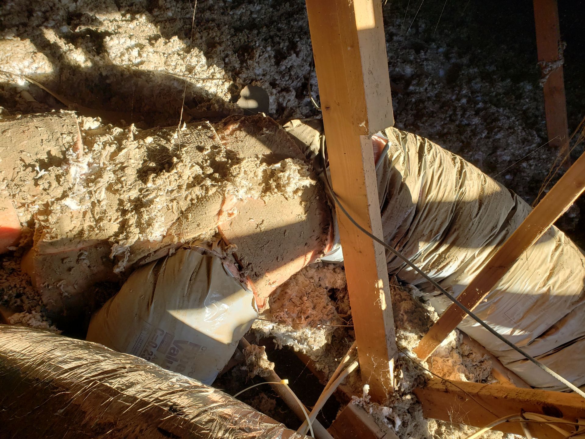 a person is laying in a hole in the ground .
