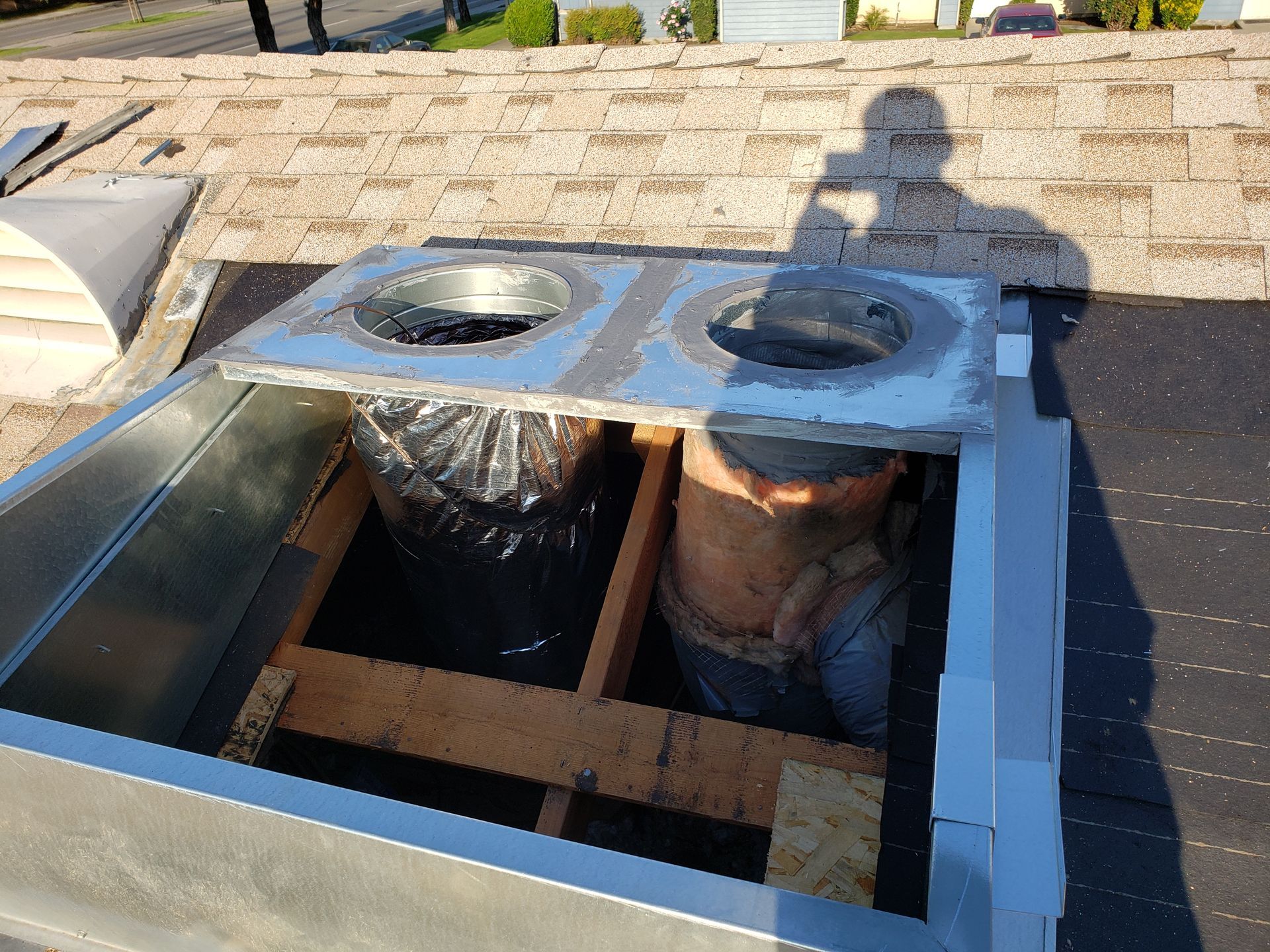 a chimney is being installed on the roof of a building .
