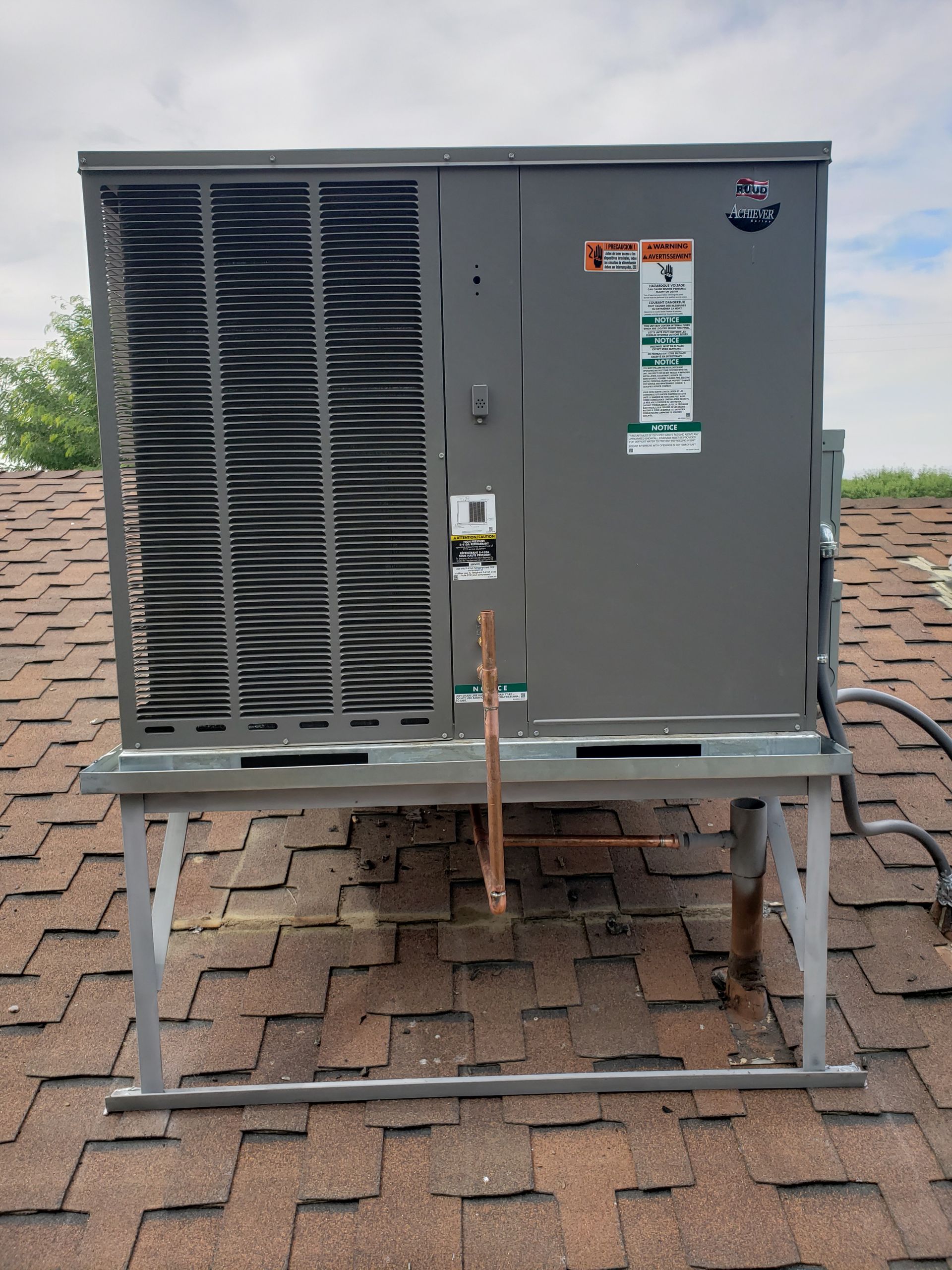 a large air conditioner is sitting on top of a roof .