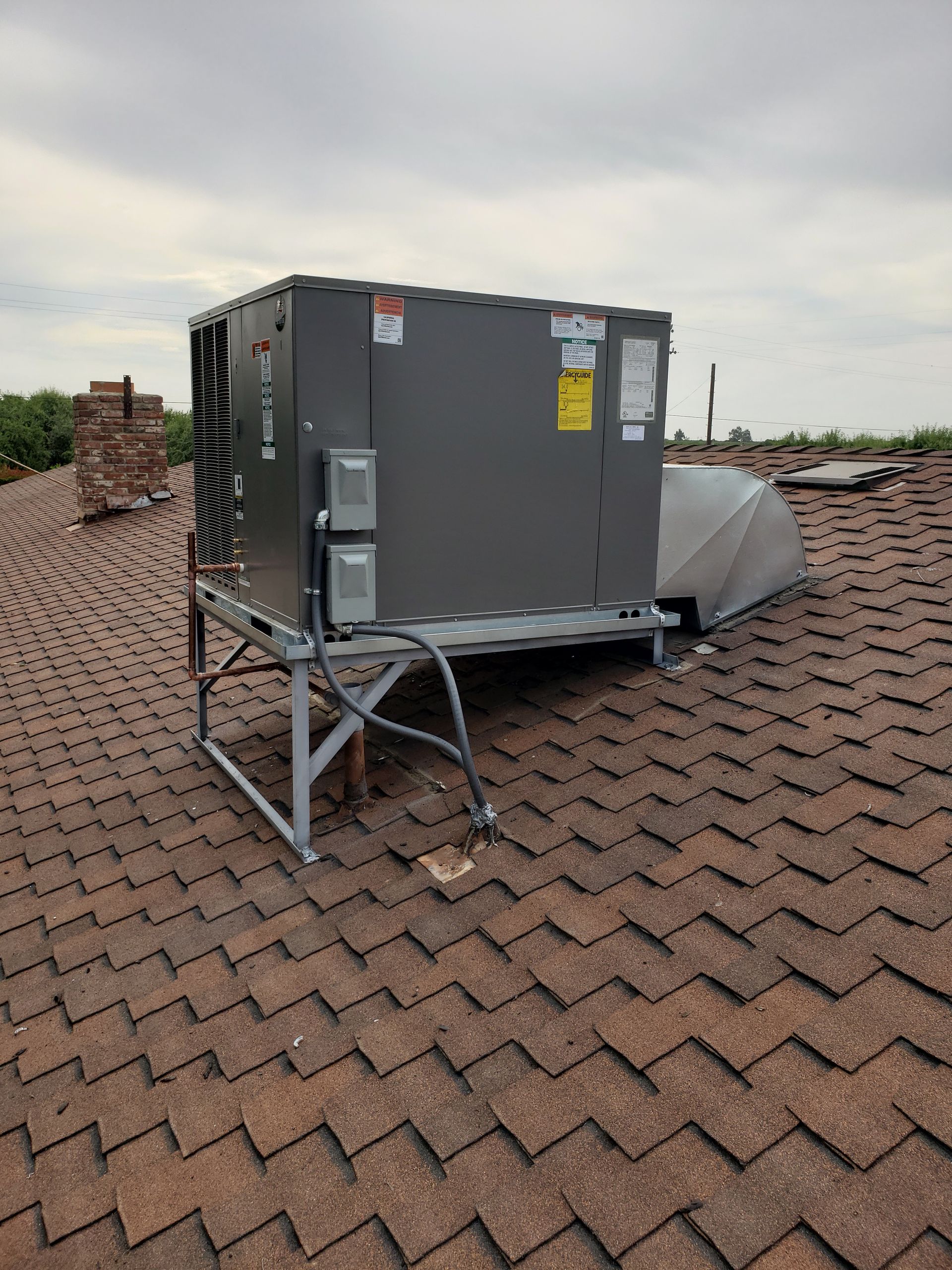 a large air conditioner is sitting on top of a roof .