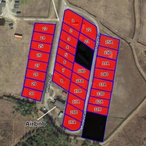 Satellite map of adjacent red-outlined land parcels labeled with lot numbers, near an Airbnb