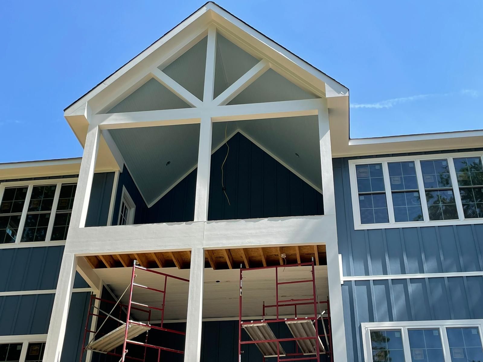 A large blue house with scaffolding in front of it