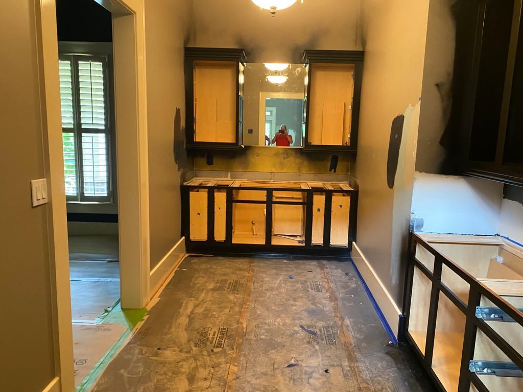 A bathroom under construction with a sink and a mirror.