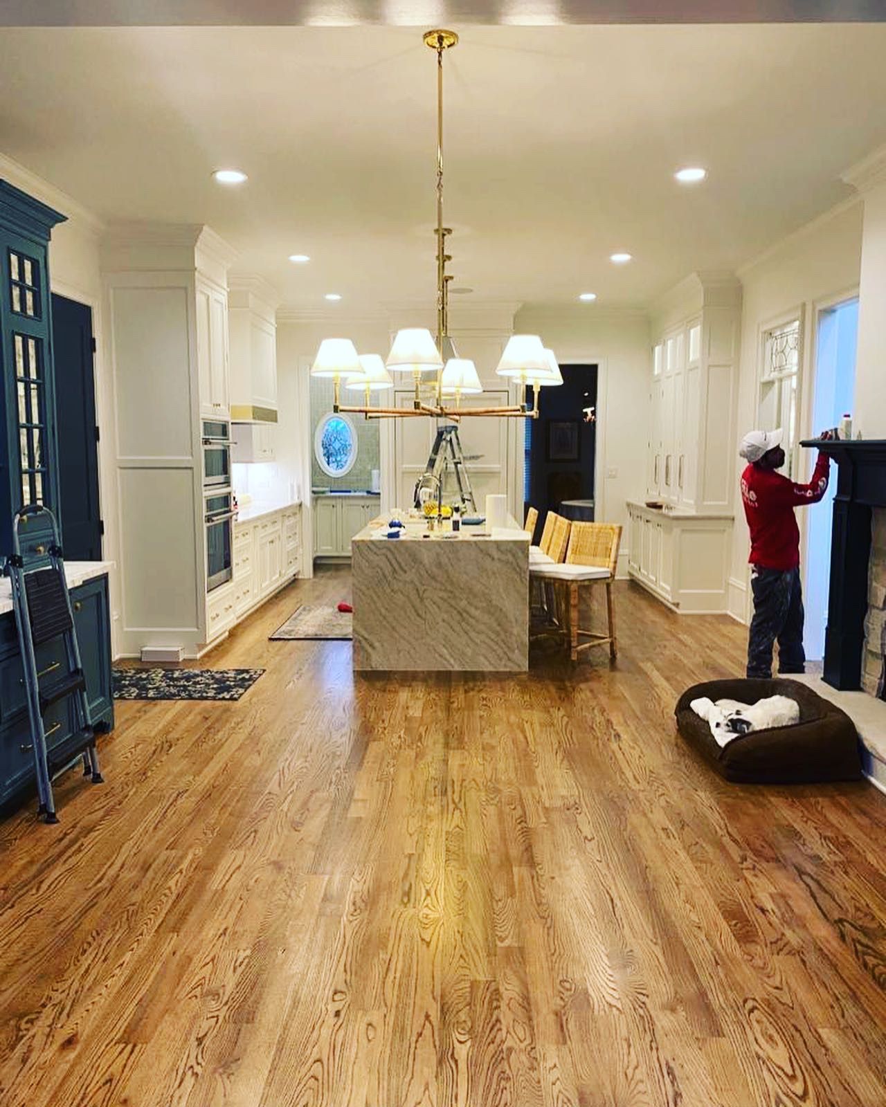 A man is working on a fireplace in a kitchen.