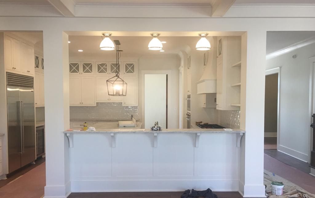 A kitchen with white cabinets and stainless steel appliances is being remodeled.