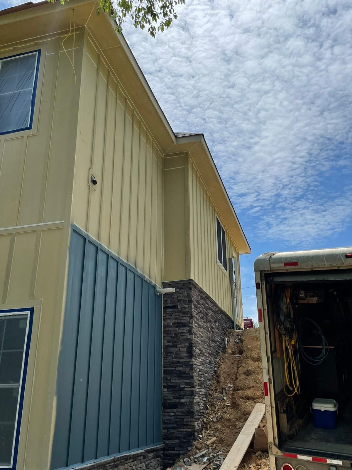 A house with a truck parked in front of it.