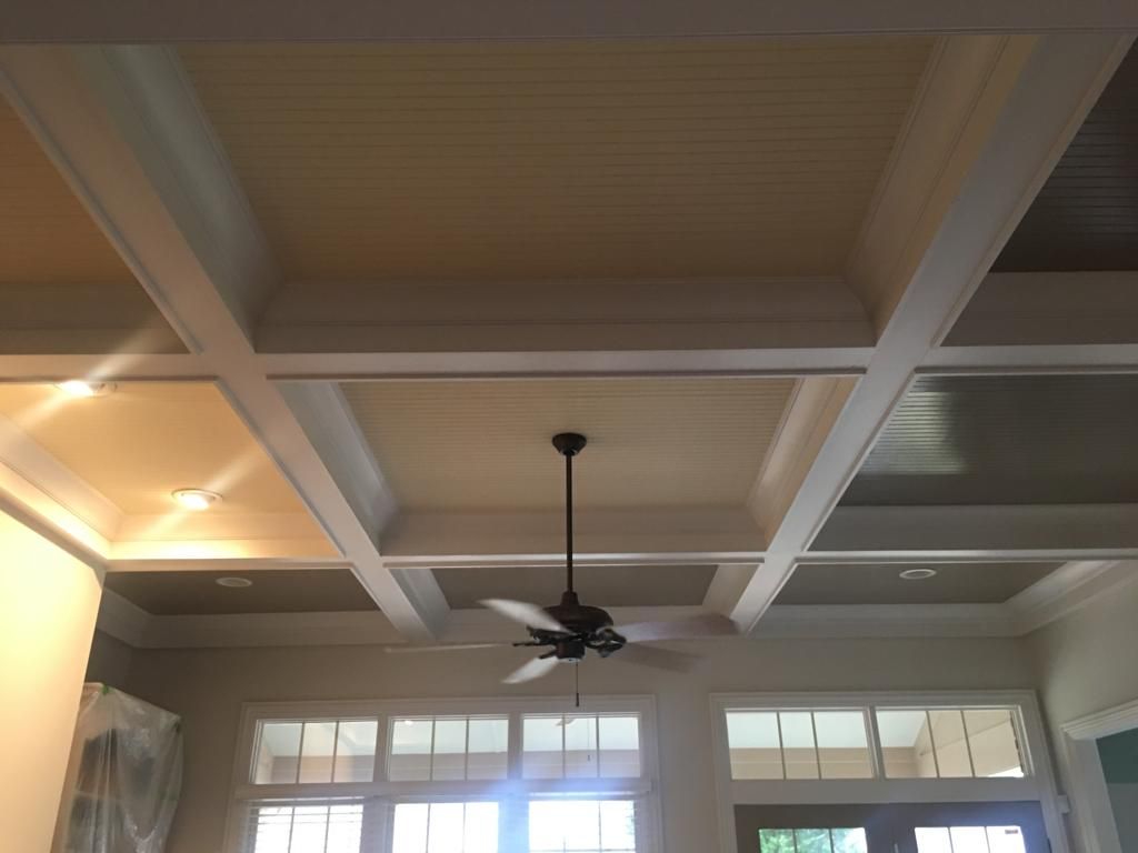 A ceiling fan is hanging from the ceiling of a room.