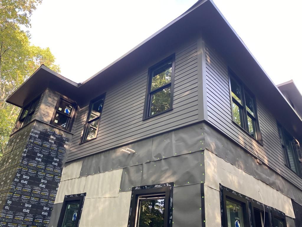 A large house with a lot of windows is being built.