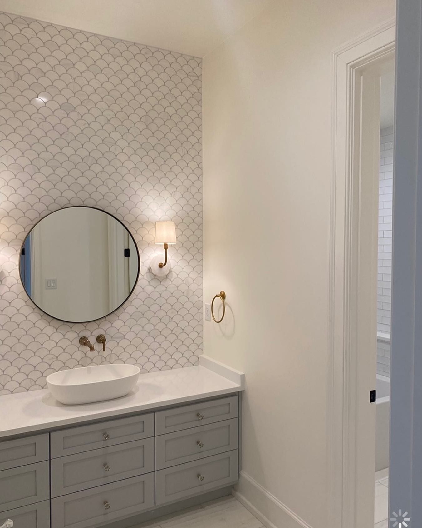 A bathroom with a sink , mirror and dresser.