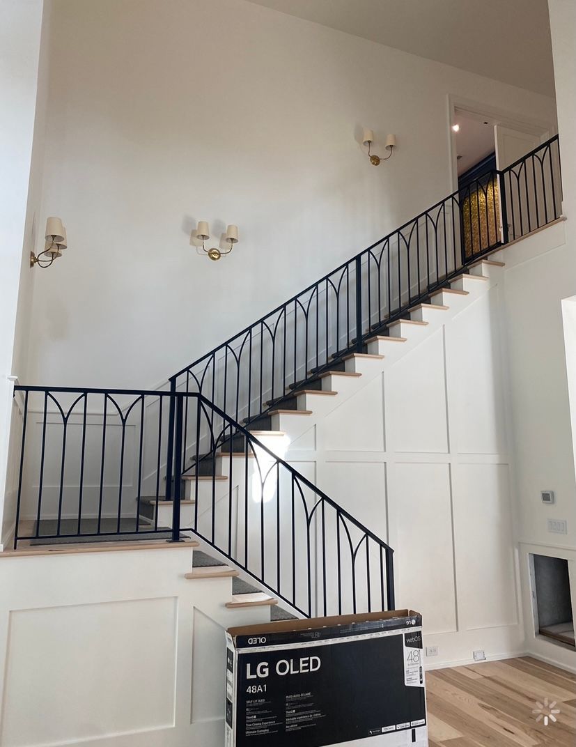 A staircase with a black railing and a box that says lg on it.