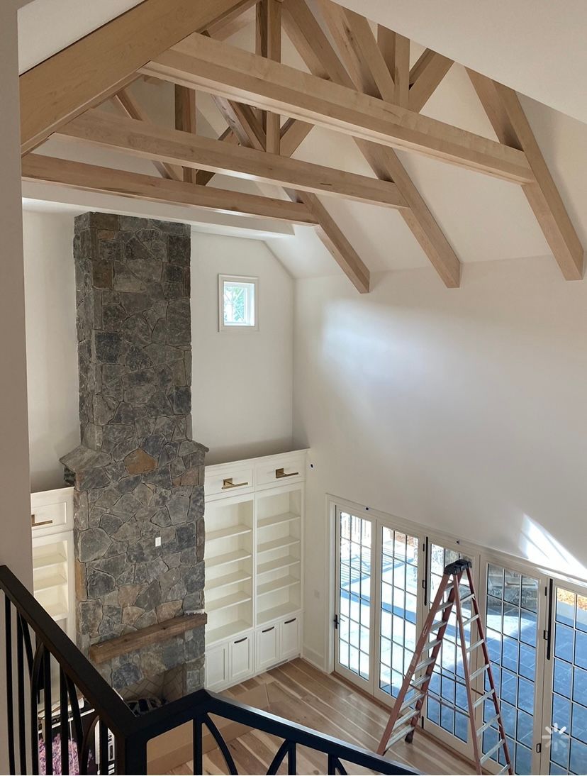 A room with a fireplace and a ladder in it