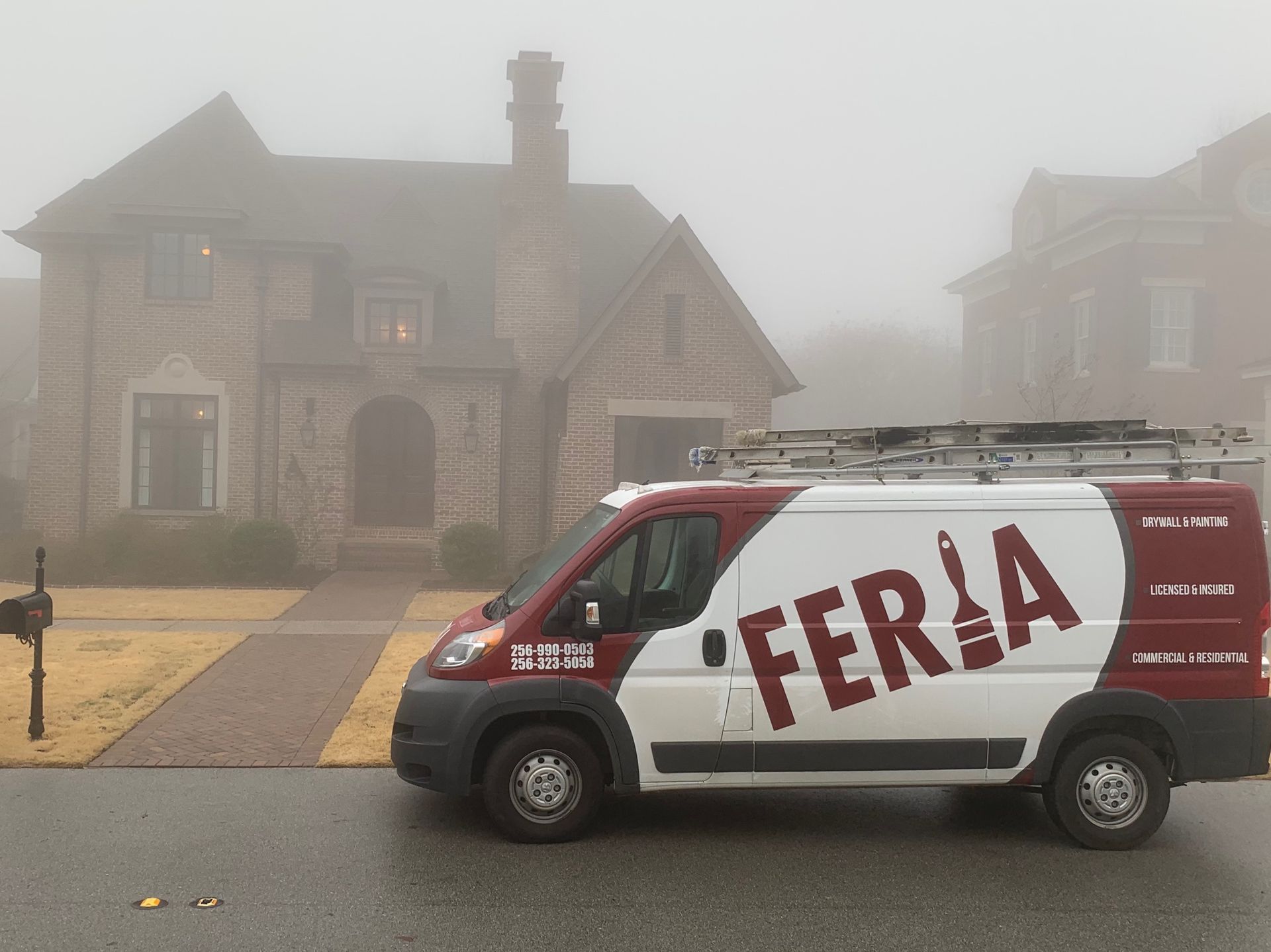A feria van is parked in front of a foggy house