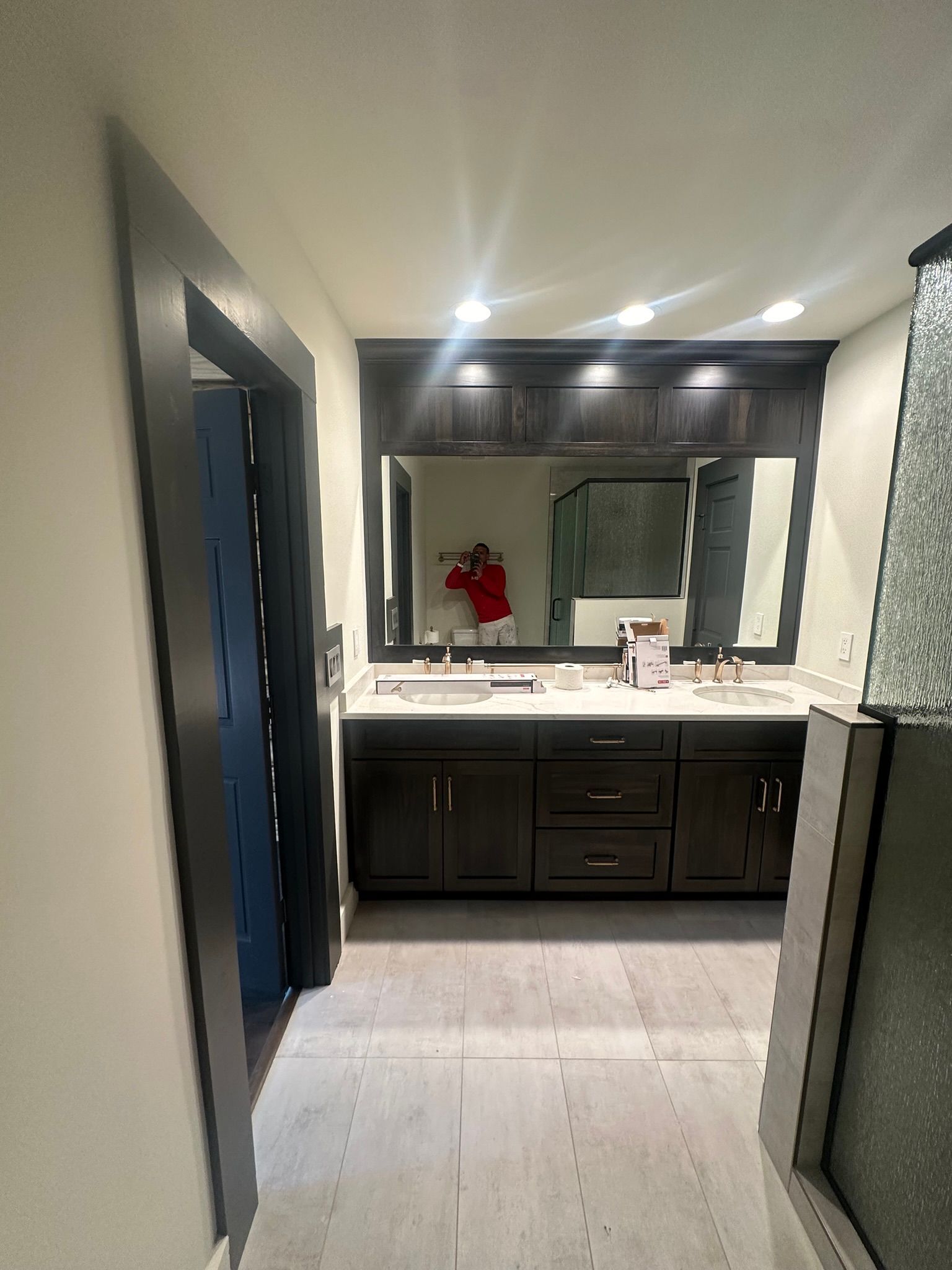 A bathroom with two sinks and a large mirror.