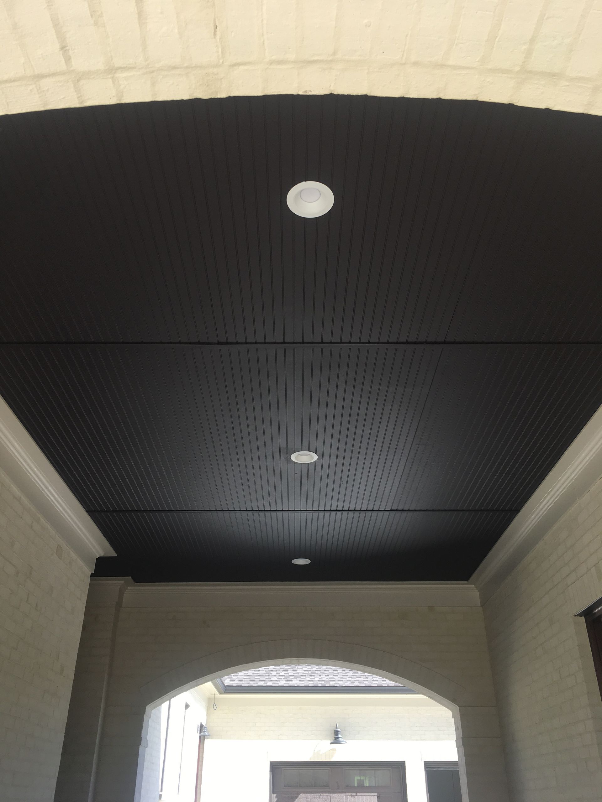 A black ceiling with a white light on it
