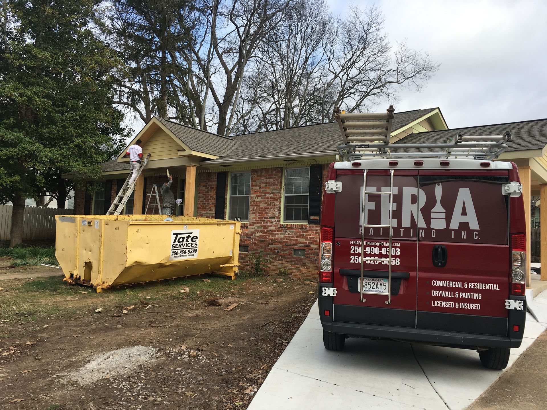 A red van with the word ferla on the back is parked in front of a house.
